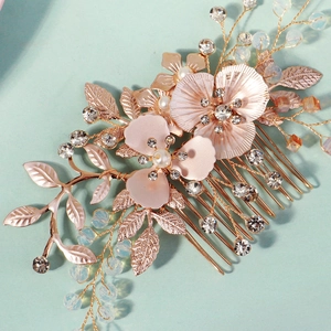 Macro detail of vintage gold flower hair comb with pink matte petals and rhinestones
