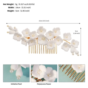 Detailed close-up showing white polystyrene flowers and imitation pearls on wedding hair comb