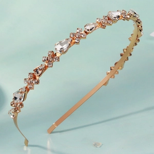 Luxurious gold headband with sparkling crystals and star-shaped accents for formal events