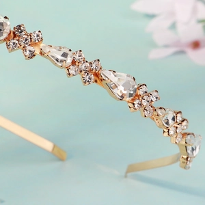 Detailed macro view of sparkling waterdrop rhinestones on a luxury gold headband