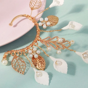 Detailed close-up of handmade floral ear cuff with white beads and pearls on wire