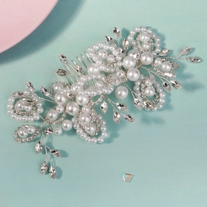 Detailed view of handmade bridal hair comb with pearls and leaf shaped crystals