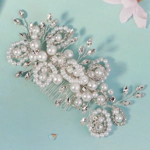 Detail of handmade bridal hair comb with silver wire, white pearls and shiny rhinestones