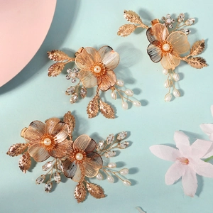 Détails macro d'épingles à cheveux fleurs en fil doré avec perles pour mariages