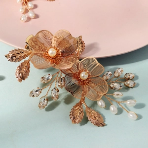 Détail de la pince à cheveux faite main avec pétales dorés, perles et strass marquise