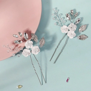 Handmade white ceramic flower hair pins with silver leaves and crystals for wedding hairstyles