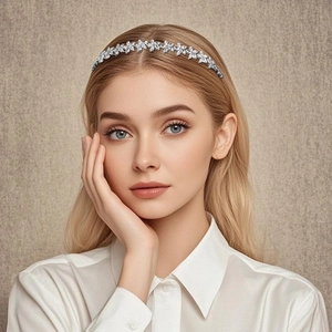 Detailed view of silver floral headband with marquise-cut rhinestones on model