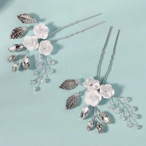 Handmade white ceramic flower hair pins with silver leaves and crystals for brides