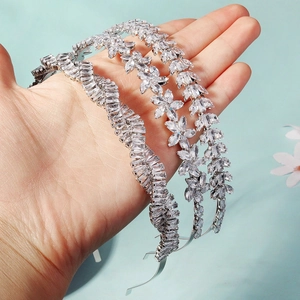 Detail showing three silver headbands with sparkling cubic zirconia floral designs
