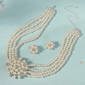 Detailed macro view of four-layer pearl necklace and matching floral earrings set