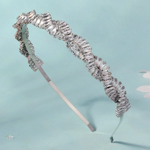Elegant wavy silver headband featuring rectangle-cut zircon stones on a light blue base