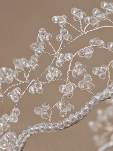 Macro shot of handcrafted branch structure with crystal beads and silver wire