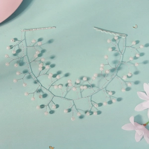 Detail of bridal hairband with silver copper wire and white pearls for wedding styling