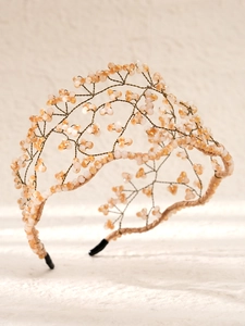 Detail of handcrafted gold wire mesh headband with champagne and pink beaded crystals