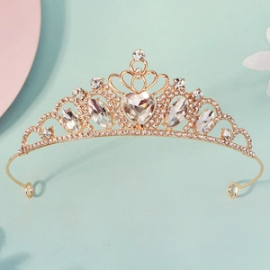 Detailed close-up of a golden crown featuring a central heart-shaped crystal on blue base