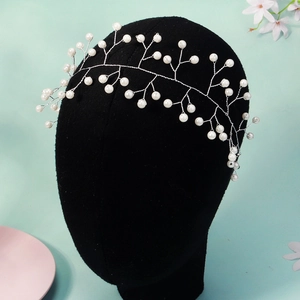 Detail of silver bridal hair vine with pearls on black mannequin head for wedding hair styles