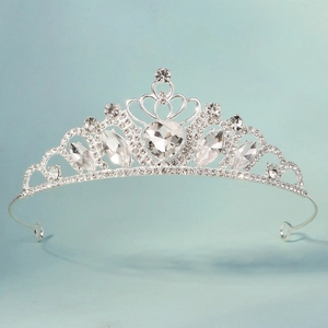 Detailed close-up of a silver tiara with heart-shaped crystal and marquise rhinestones