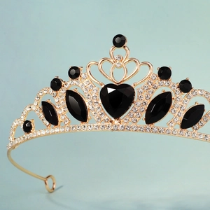 Golden princess crown with sparkling white rhinestones and large black heart-shaped gemstone