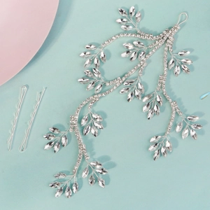 Detailed macro view of silver rhinestone leaf bridal headpiece with matching bobby pins