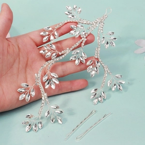 Detail of silver leaf bridal hair vine with sparkling crystals and matching hair pins