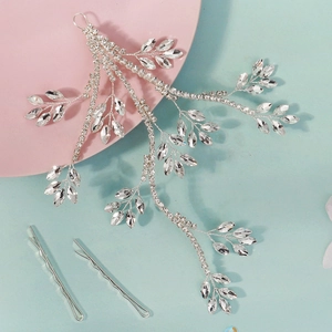 Macro detail of silver bridal rhinestone hairband with branch vine leaf patterns