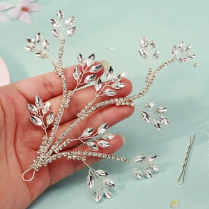 Detailed close-up of bridal rhinestone leaf headpiece with silver branch wiring