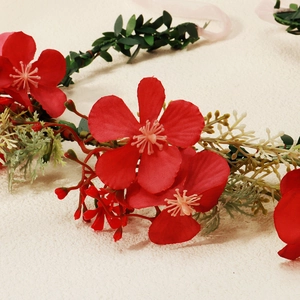 Handmade floral garland headband with vibrant red flowers for wedding hair styling