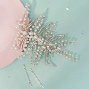 Detail of handcrafted bridal headband with pearls, crystal leaves and silver hair clips