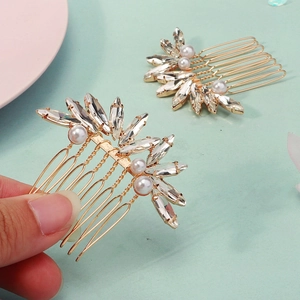 Dettaglio dei pettini da sposa fatti a mano in oro con cristalli marquise e perle bianche