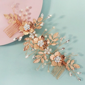 Luxurious white floral bridal hair comb with gold leaves pearls and sparkling rhinestones