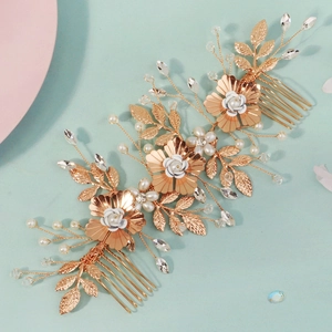 Detailed close-up of handmade bridal floral hair comb with pearls and golden leaves