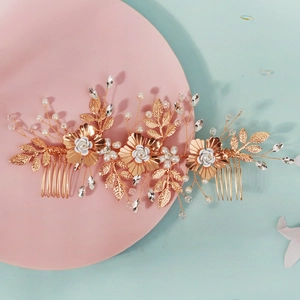 Detail of luxury bridal hair comb featuring champagne gold flowers and white pearls