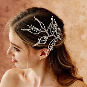 Side view detail of a bridal rhinestone hairpiece with sparkling leaf branch design