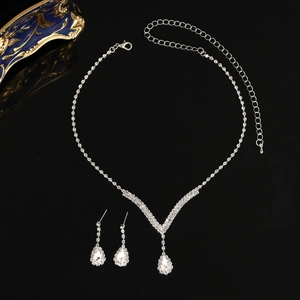 Macro view of bridal jewelry set with pear-cut rhinestones and silver-plated claw chain
