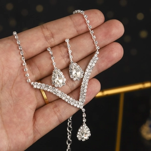Elegant silver bridal jewelry set with sparkling rhinestone necklace and teardrop earrings