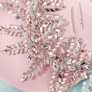 Détail d'un bandeau de mariée fait main avec feuilles en fil d'argent et strass brillants
