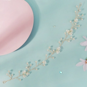 Détail du bandeau de mariée fait main avec fleurs blanches et perles sur fil doré