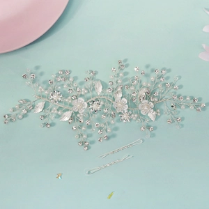 Detail of silver bridal hair vine with white flowers, pearls, and crystals including clips