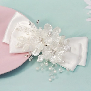 Elegant white satin bridal bow hair clip with handcrafted resin flowers and pearls