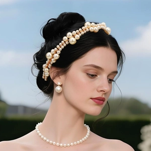 Elegant bridal pearl headband with matching necklace and earrings on a model