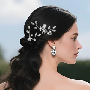 Detail of silver bridal hair pin and waterdrop earrings with crystals and pearls