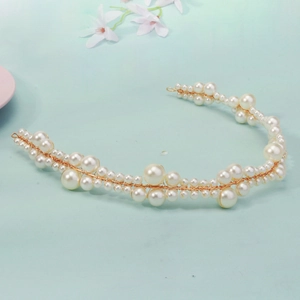 Detailed macro of handmade white pearls and gold wire weaving on bridal headband