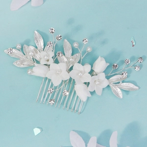 Detail of handmade bridal hair comb with white clay flowers, pearls and crystals