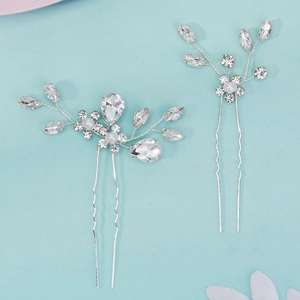 Detail of silver bridal hair pins with clear rhinestones and white pearls for weddings
