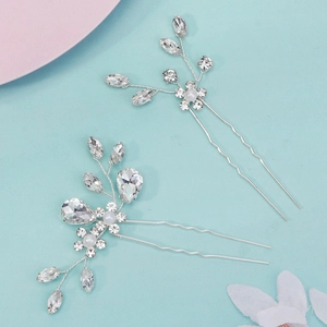 Detail of handmade silver bridal hair pins with clear rhinestones and pearls floral design