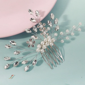 Detailed view of silver bridal hair comb with pearls and marquise cut rhinestones