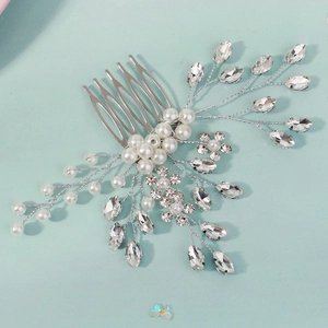 Detail of silver bridal hair comb with pearls and rhinestones on mint background