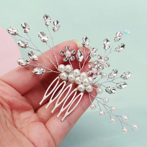Detailed shot of silver bridal hair comb with rhinestones and white pearls for weddings