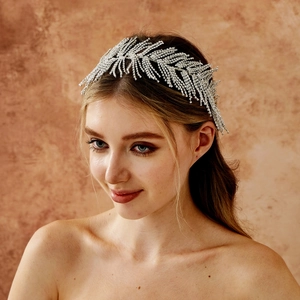 Detail of silver rhinestone bridal headband with leaf design and sparkling crystals