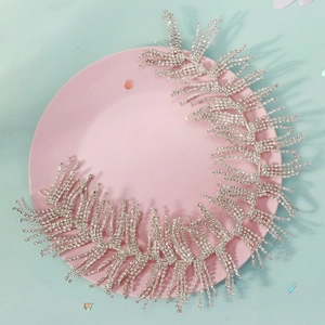 Detail of silver rhinestone bridal headband with sparkling tassel and leaf motifs